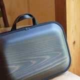 Our Flag Ship line Black with shoulder strap. More you use color change every day. Please enjoy the scent of real wood.■ Material: Cedar, cotton canvas, hides, urethane paint (water-repellent finish)■ Size: Approximately W18 X H12 X D2.8 inch, W18 X H15 X D2.8cm (including the handle)■ Weight: Approximately 930 g / 2 lbs■ Specifications: There are 2 middle sizes inner pocket at one side Double fastener make easy open and close B4 size documents storing is possible 17 inches of note PC storing is possible